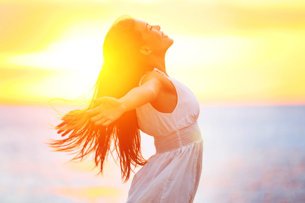 woman welcoming the warm spring sunrise