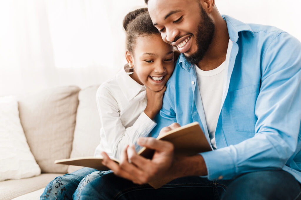 Dad reading with his daughter
