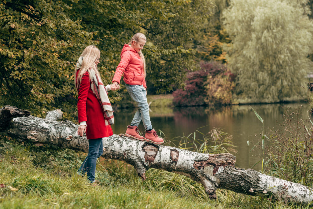 Woman and daughter outside in nature walking to help with eliminating negative thoughts