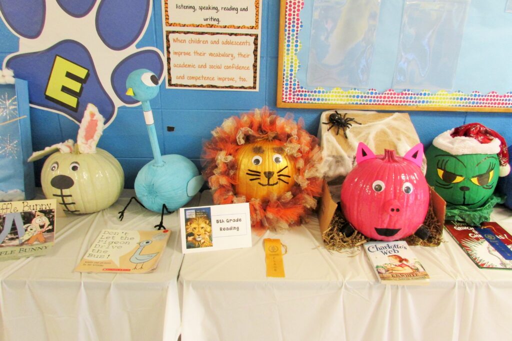 painting pumpkins like characters as part of Thanksgiving celebration