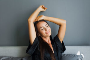 Young teacher stretching as she wakes up for the day