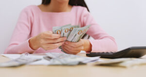 teacher planning for her financial future; teacher counting money