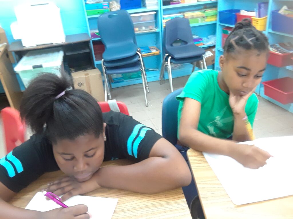 Girls working together on writing