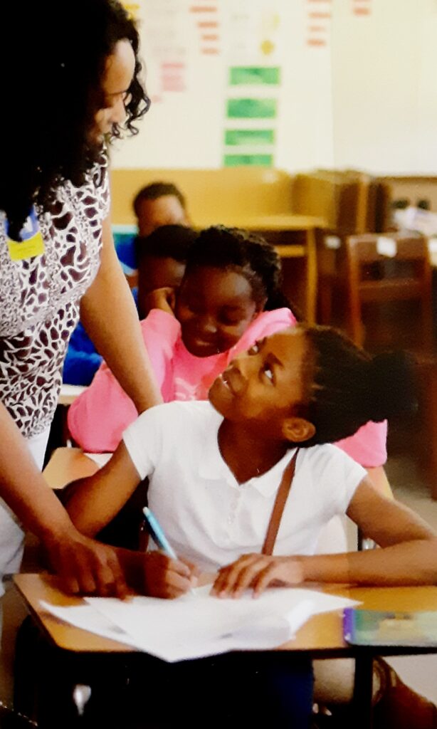 Teacher helping students with journaling activity