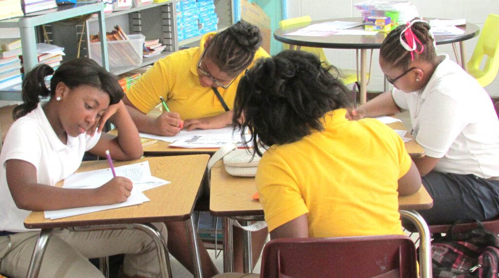 Students in writing group using rubric to complete assignment