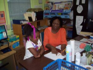 teacher helpinng student with rubric