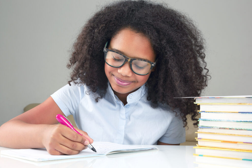 happy african american girl writing 