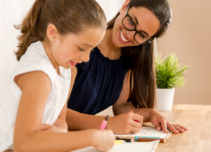 Teacher working with student on sentence editing