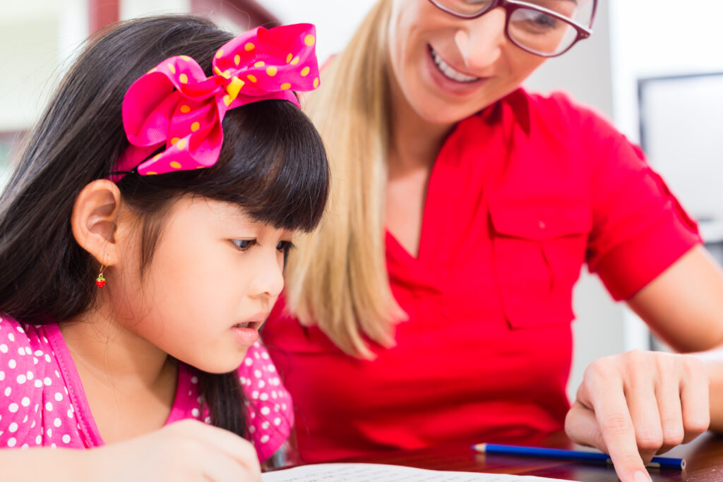 Teacher working with Asian student at the students' own level