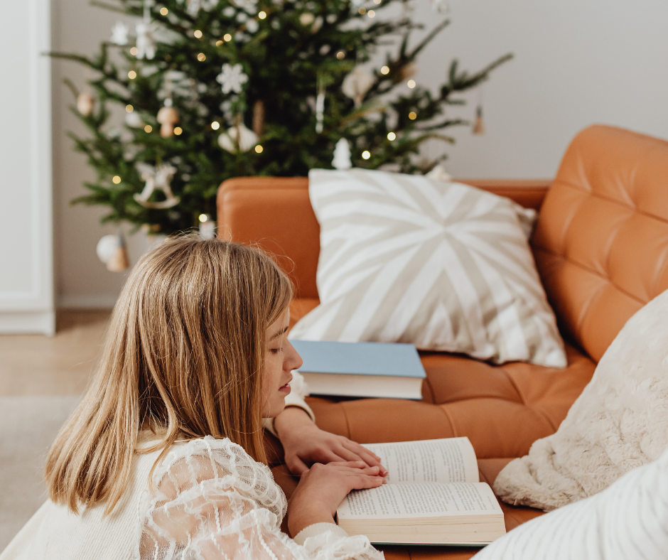 homeschooling girl reading holiday book in reading nook