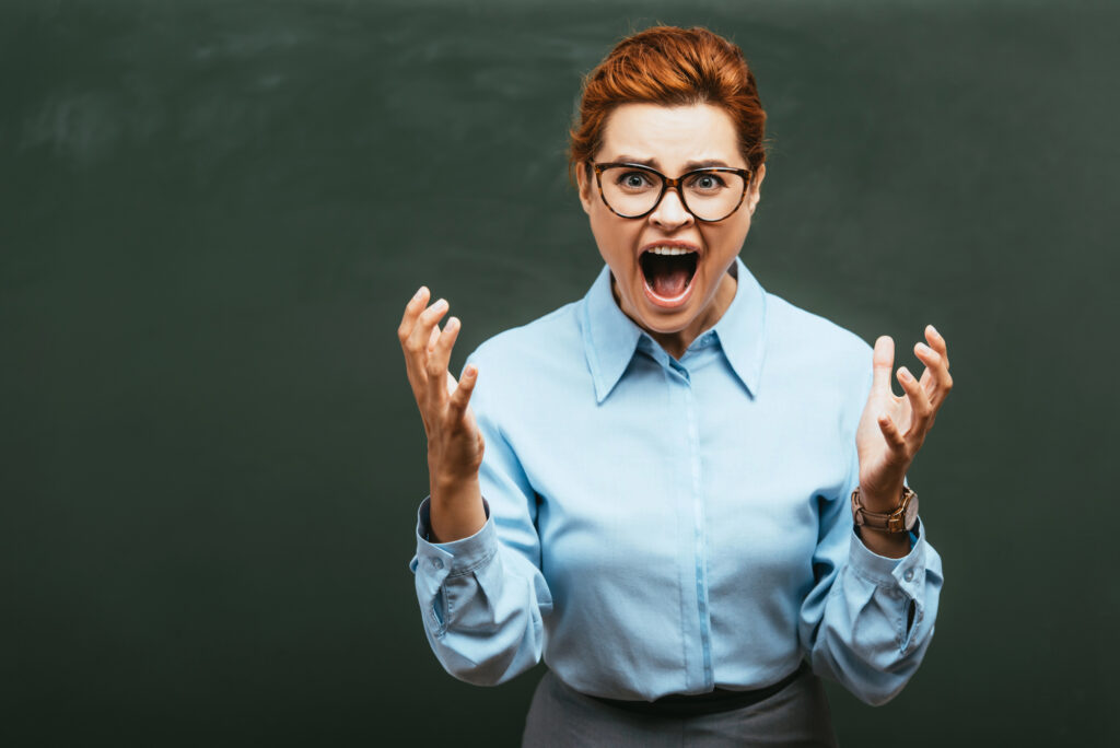 frustrated teacher yelling in response to student misbehavior