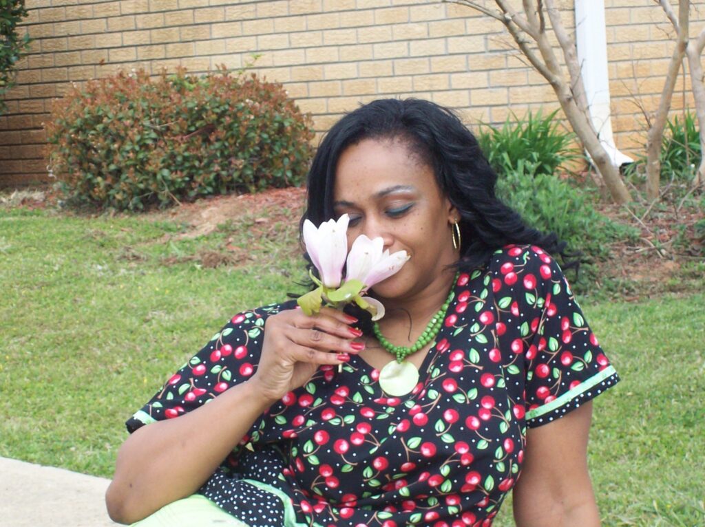 attractive woman smelling spring flowers that can help students learn theme