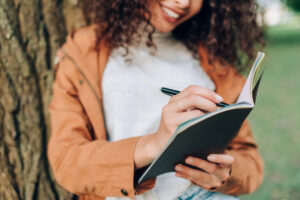 teacher writing in journal to help with her mental health