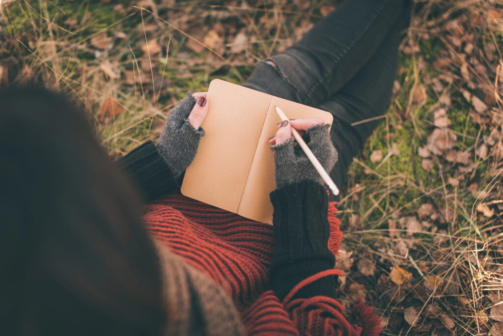 teacher journaling outdoors