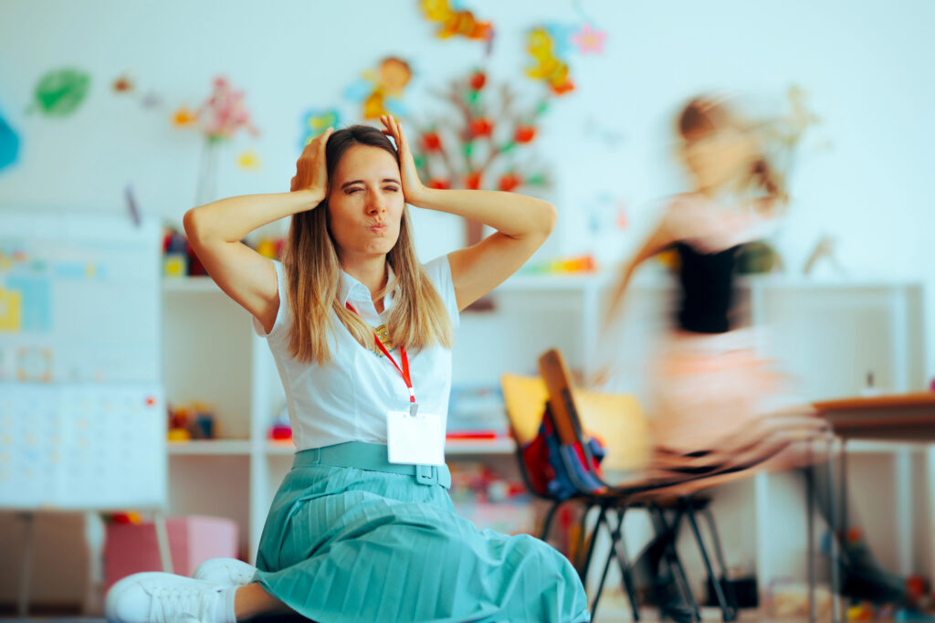 frustrated teacher in class with her hand on her head