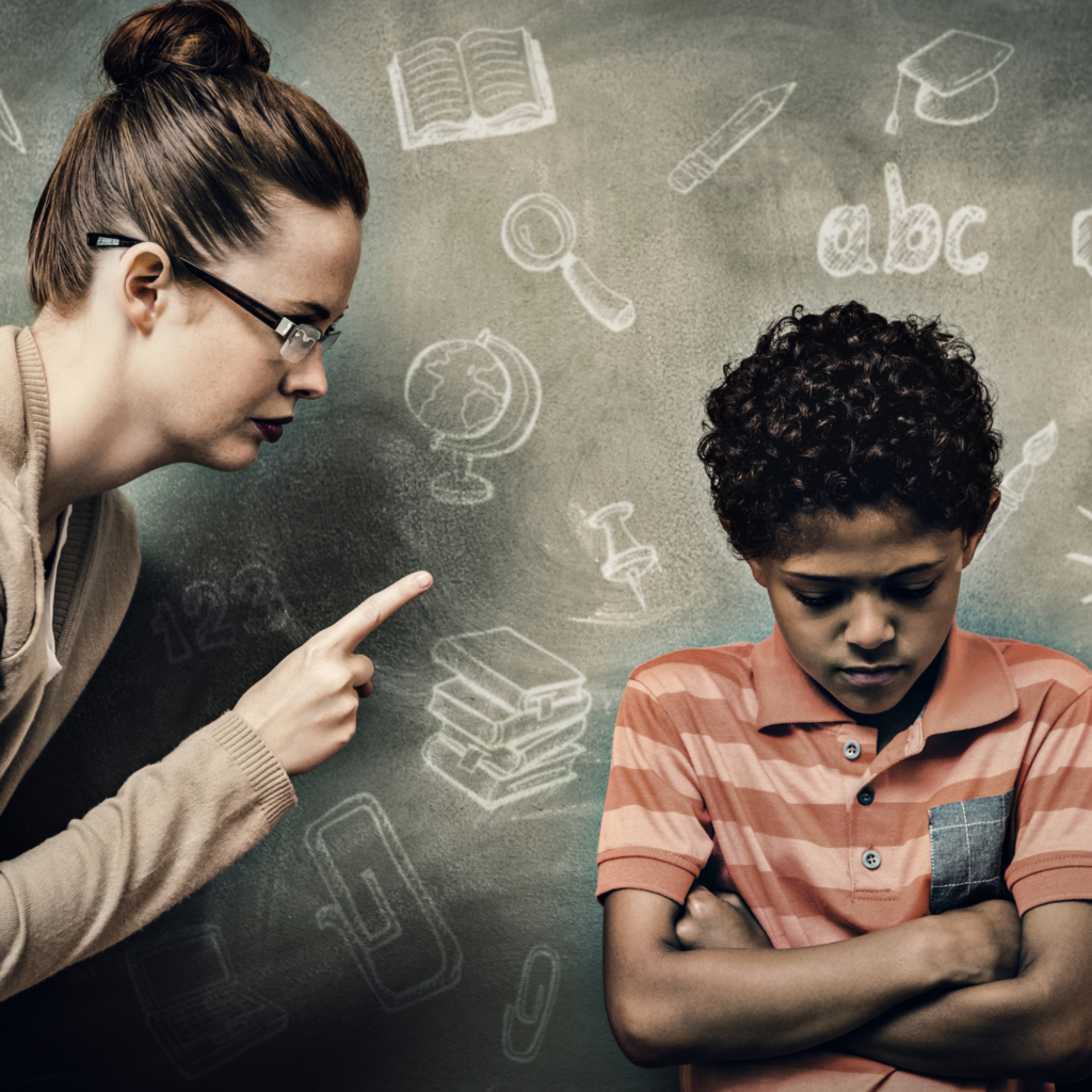 teacher pointing her finger at misbehaving male student